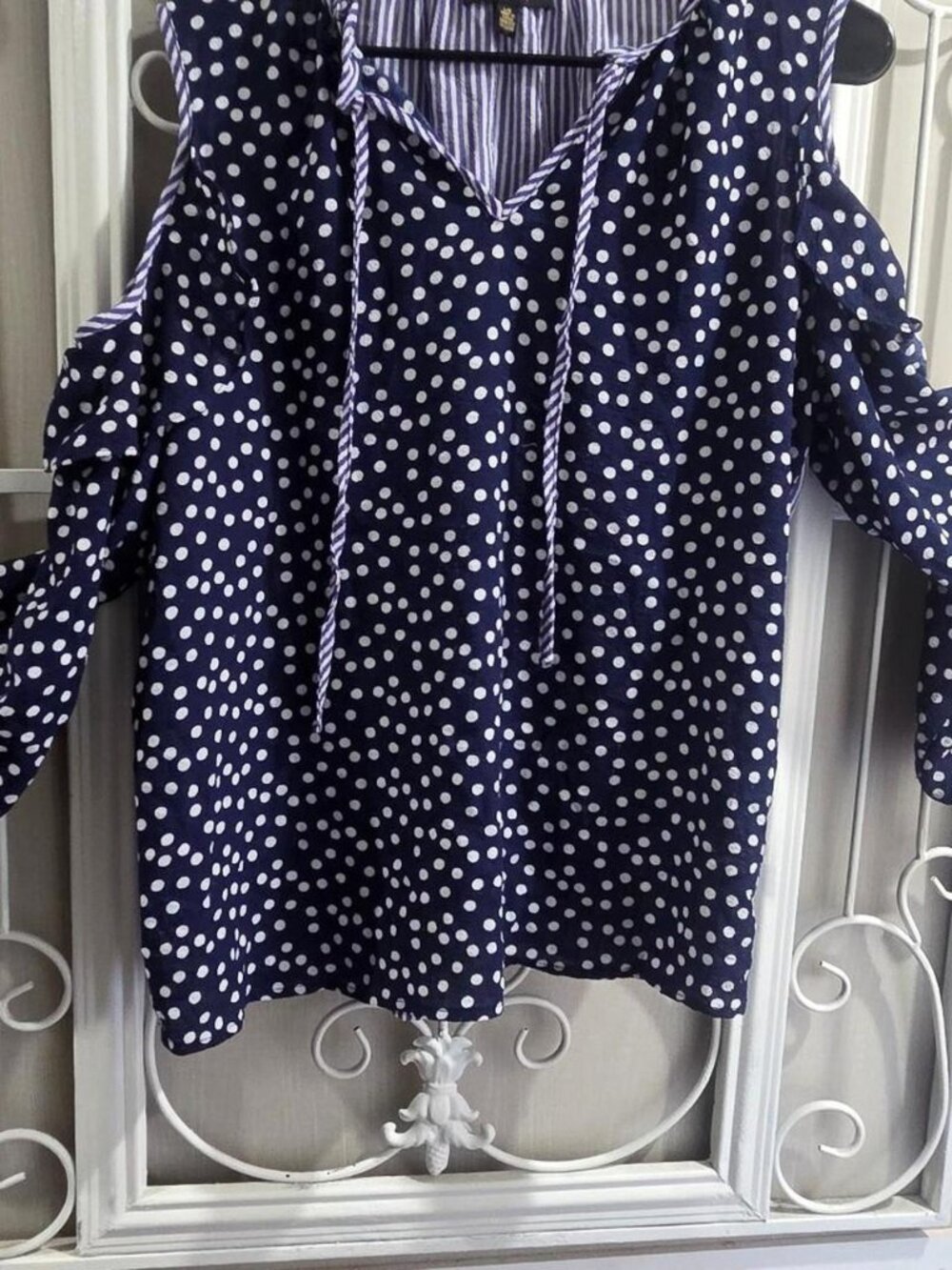 Navy blue polka dot cold shoulder blouse with striped sleeves. Size: L